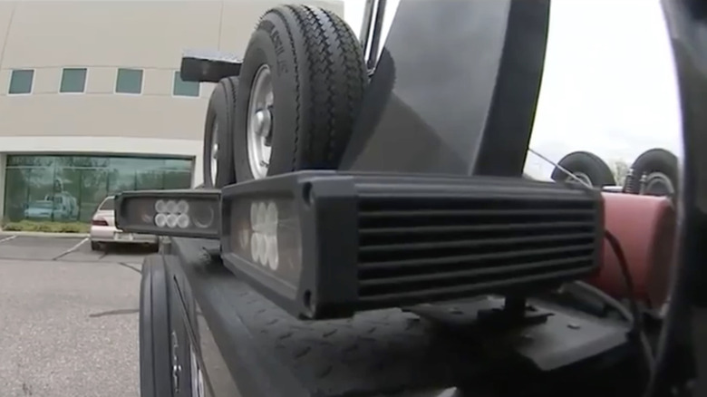 Close-up of two automatic license plate readers mounted to the side of a tow truck used for auto repossession