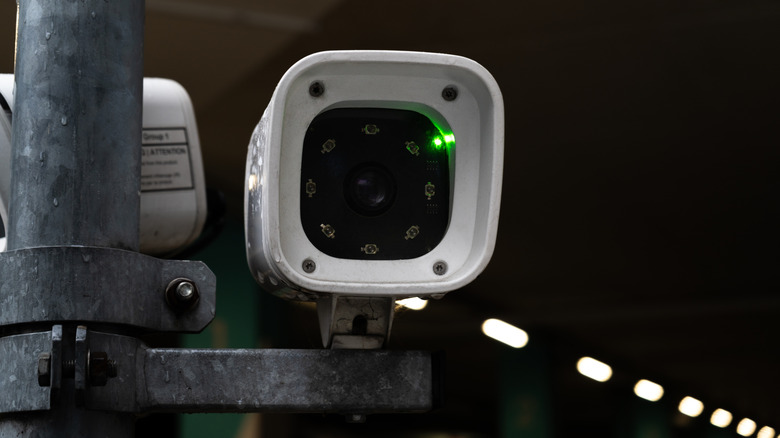 Close-up of a camera scanning license plates at a parking garage entrance