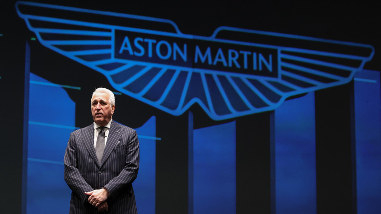 Lawrence Stroll in front of an Aston Martin sign