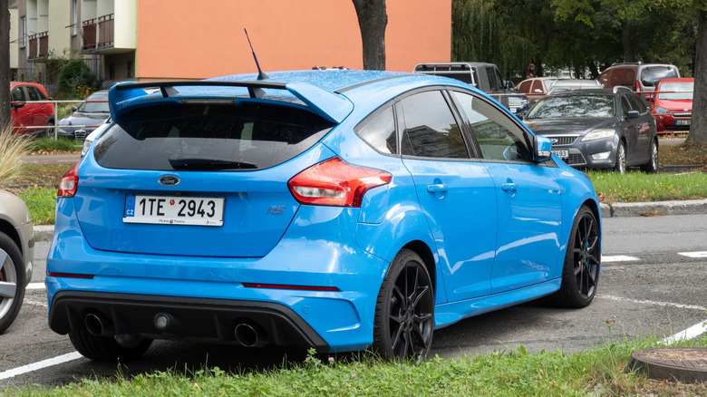 A rear three-quarter view of blue Ford Focus RS parked on a street