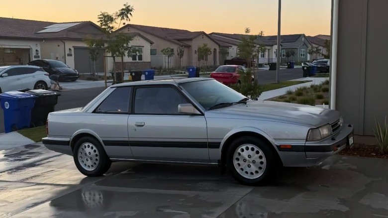 1987 Mazda 626 Turbo Coupe in a driveway at sunset image
