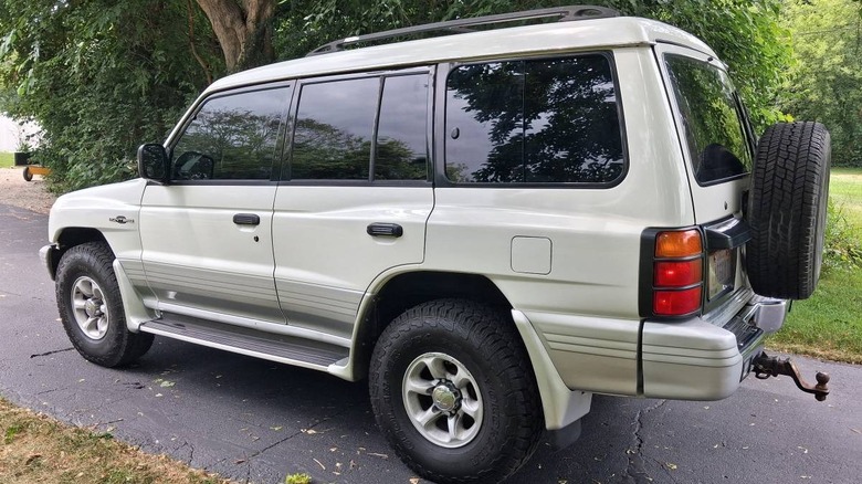 2000 Mitsubishi Montero Limited rear 3/4 parked on an asphalt driveway under trees