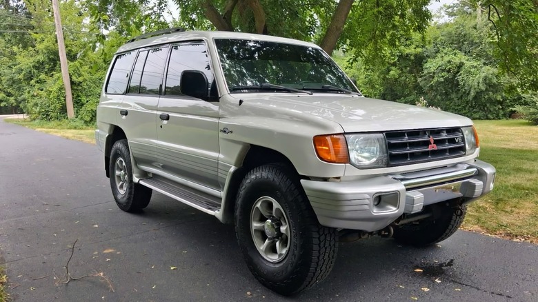 2000 Mitsubishi Montero Limited front 3/4 parked on an asphalt driveway under trees