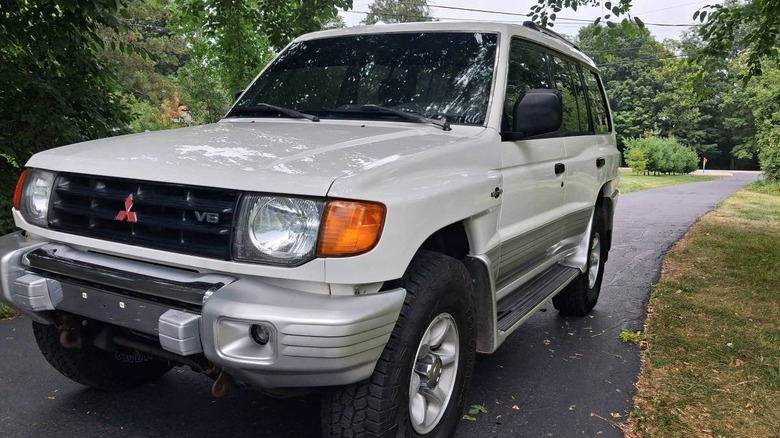 2000 Mitsubishi Montero Limited front 3/4 parked on an asphalt driveway under trees