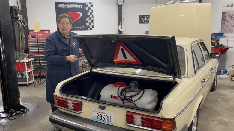 Rear 3/4 view of a Mercedes W123 with a second fuel tank for waste vegetable oil in the trunk