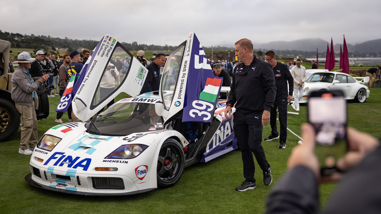 A parked 1996 McLaren GTR with its doors up at Pebble Beach Concours d'Elegance, Monterey, 2024.