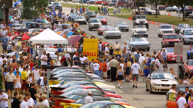 Aerial view of the Woodward Dream Cruise, showing crowds and cars in motion and parked.