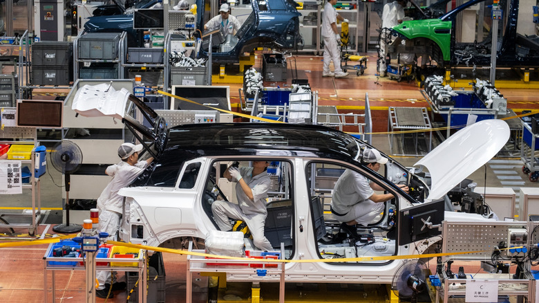 An electric car production assembly line is seen at the GAC Aion Intelligent Ecological Factory in Guangzhou, Guangdong, China, on Friday, September 26, 2025.