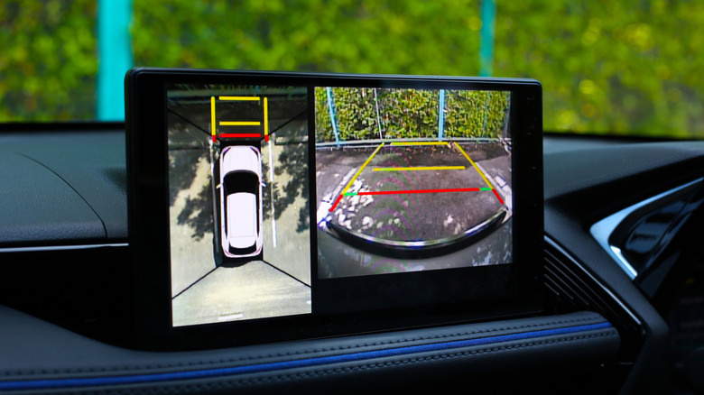 A close-up of a car central display showing a 360 degree camera feed.