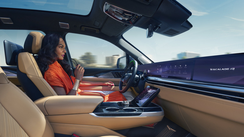 Woman in a Cadillac Escalade IQ