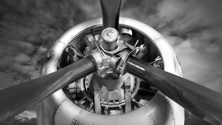 A Douglas airplane shows off its propellor and the forward portion of its engine