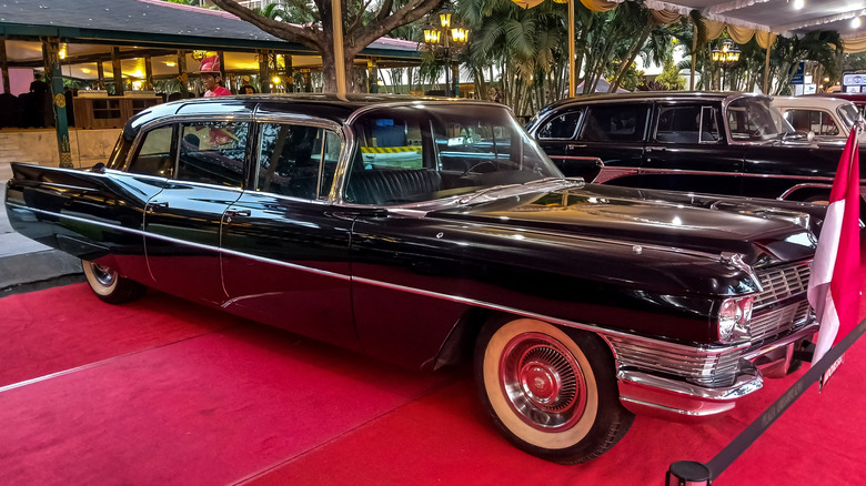 Black 1960s Cadillac Fleetwood connected a reddish carpet display