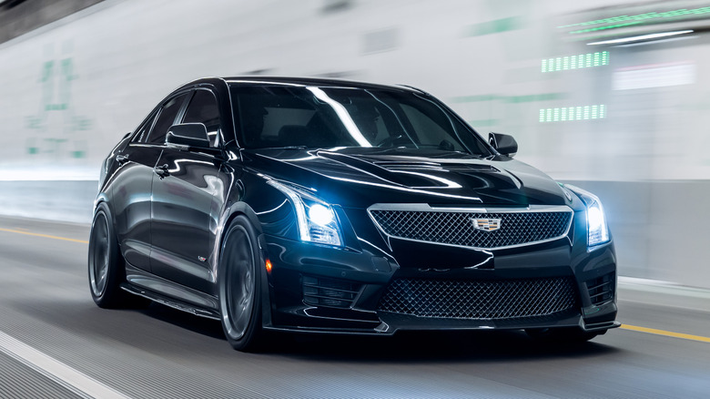 Black Cadillac Escalade connected show astatine a car show