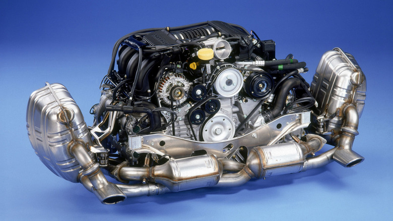 Porsche's completely new, flat-six water-cooled engine, designed for the 996 generation of the 911 Carrera on a blue background.