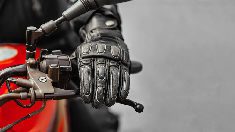 Hand in glove on motorcycle brake handle