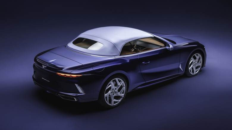 Rear 3/4 view of a blue Bentley Batur convertible with the roof up