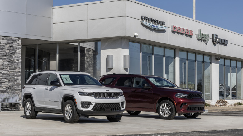 Jeep Grand Cherokee and Dodge Durango SUV display at a Stellantis dealership. Chrysler and Ram Trucks are part of Stellantis.