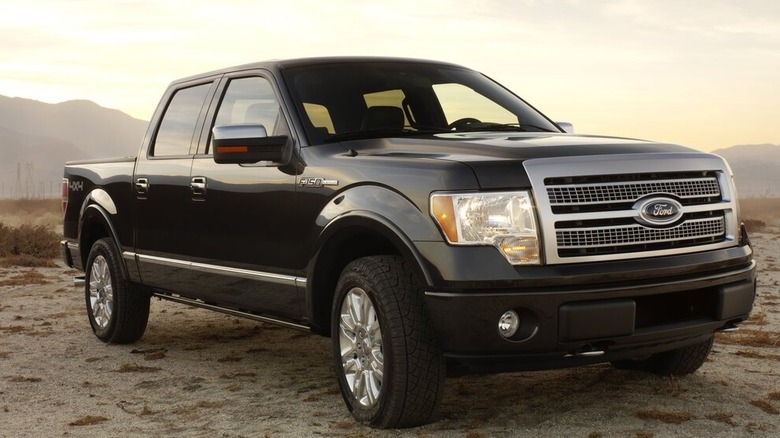 A black 2008 Ford F-150 on desert terrain.