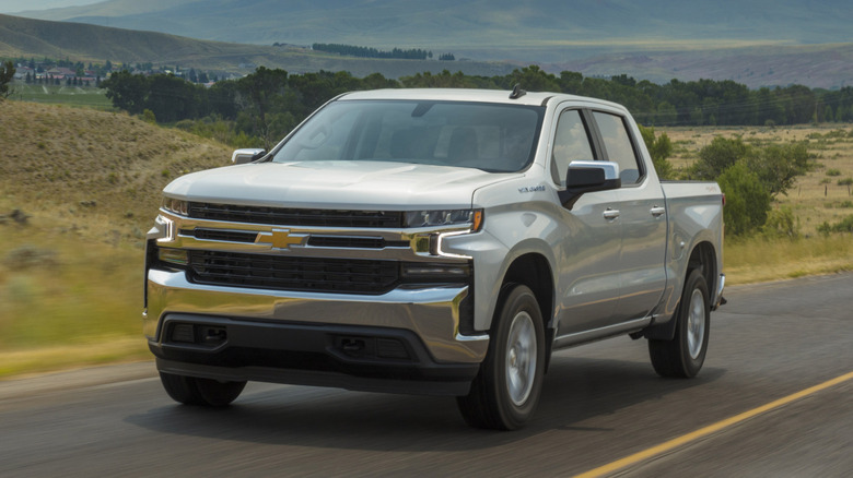 A silver 2021 Chevrolet Silverado 1500 on a road.