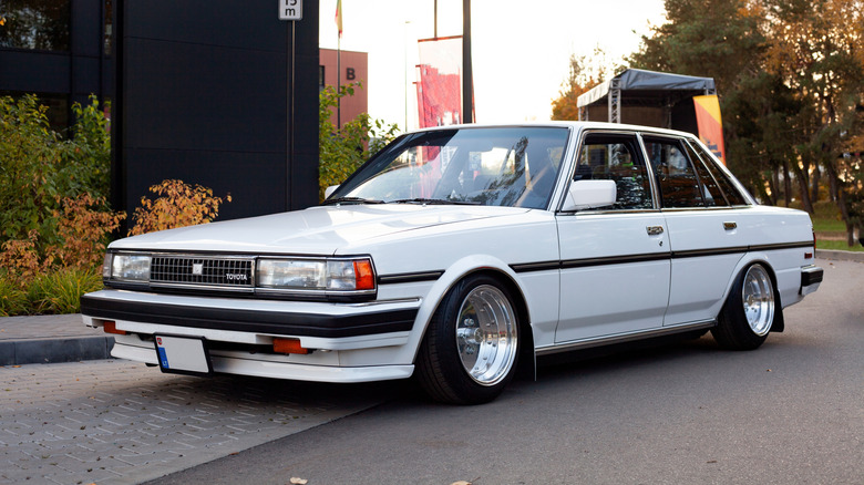 A Toyota Cressida sedan lowered on aftermarket wheels.