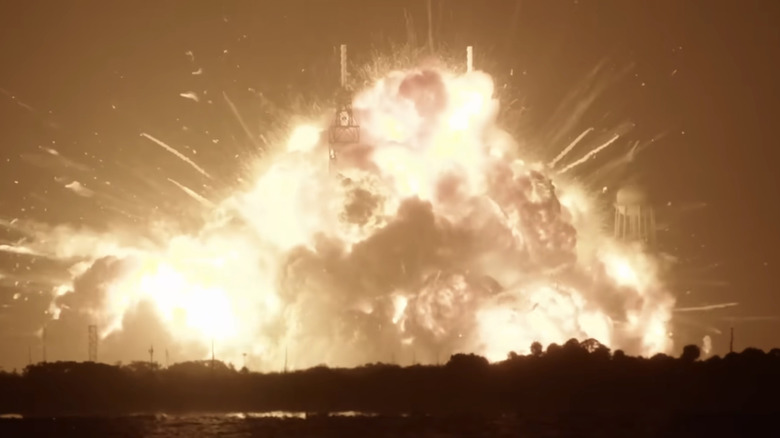 A fireball surrounds a Blue Origin New Glenn rocket on the launch pad during an engine test
