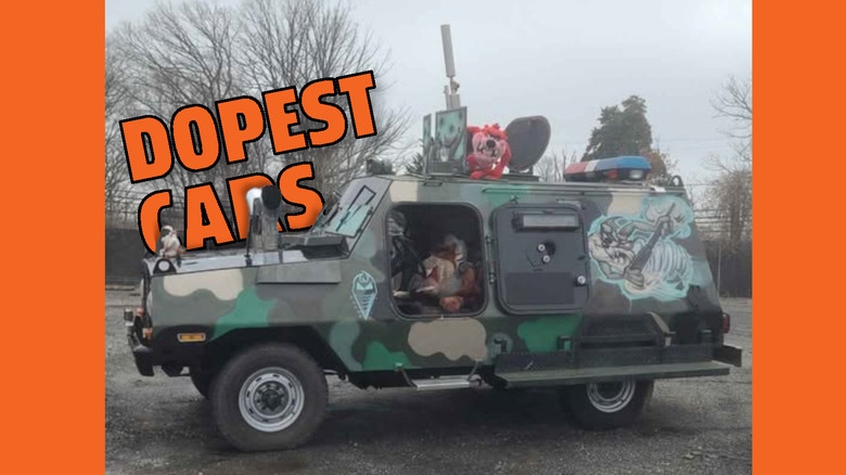 Some sort of camouflaged vehicle covered in Taz paint and plushies