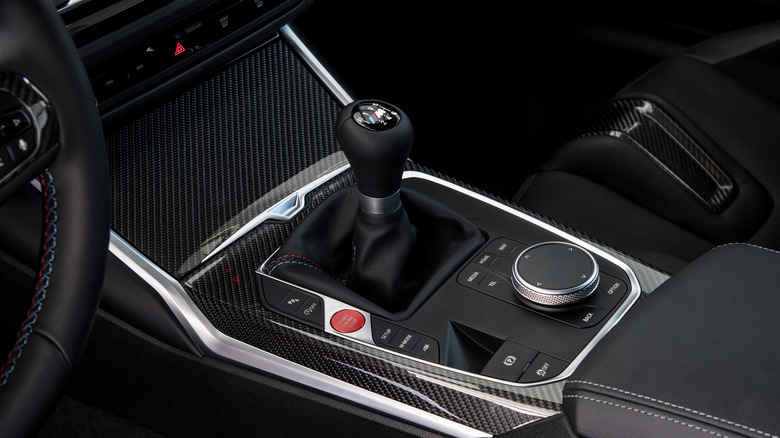 An interior shot of a BMW M2 showcasing its manual trasmission lever.