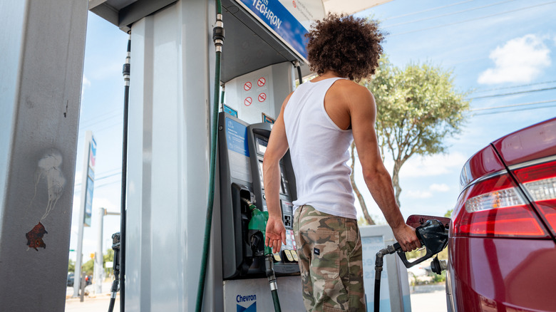 A person pumps gas at a Chevron gas station on August 07, 2026 in Austin, Texas.