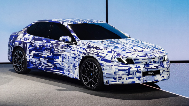 Front 3/4 view of a camouflaged BMW i3 sedan