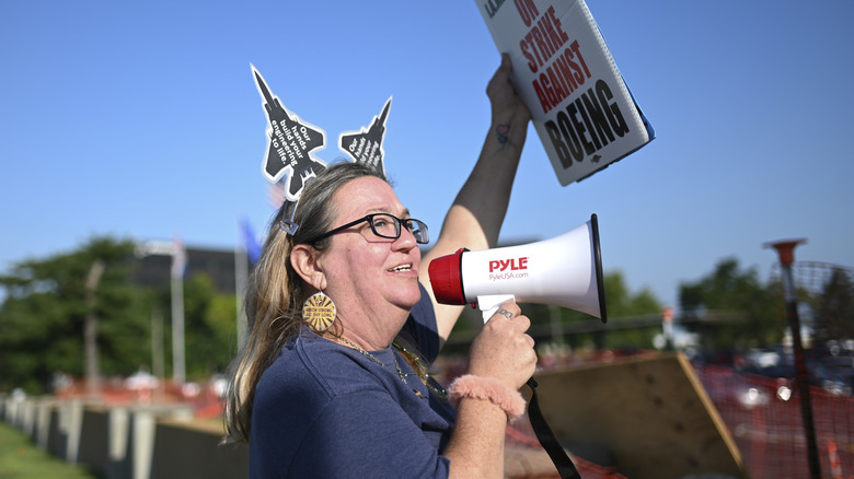 A Boeing machinist on strike, holding a megaphone