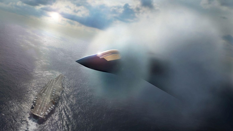 Artist's rendering of an F/A-XX in flight, surrounded by fog, over an aircraft carrier