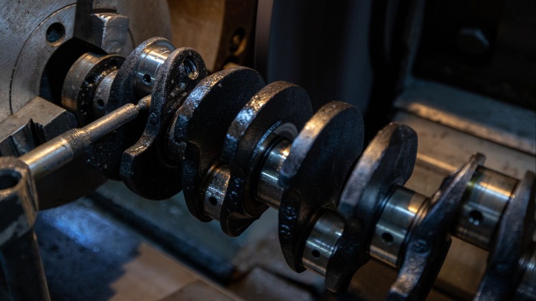 A crankshaft chucked in an engine lathe.