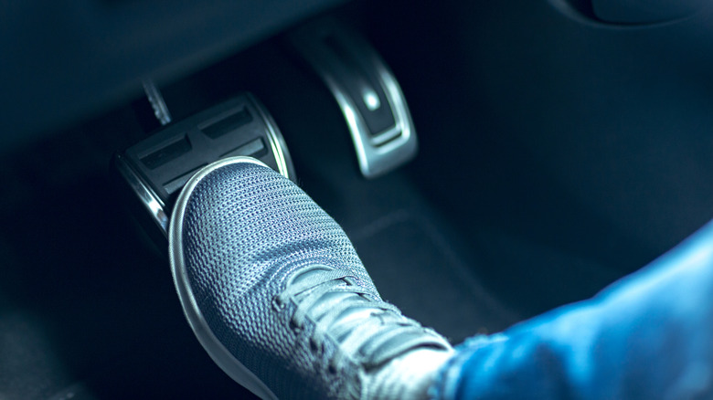 Foot pressing on a car's brake pedal