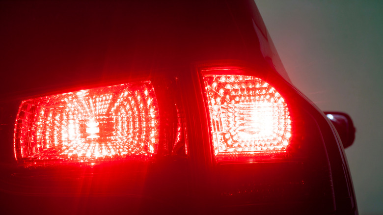 Taillights of a crossover SUV with the brake lights on