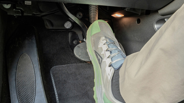 Driver's foot pressing on the brake pedal