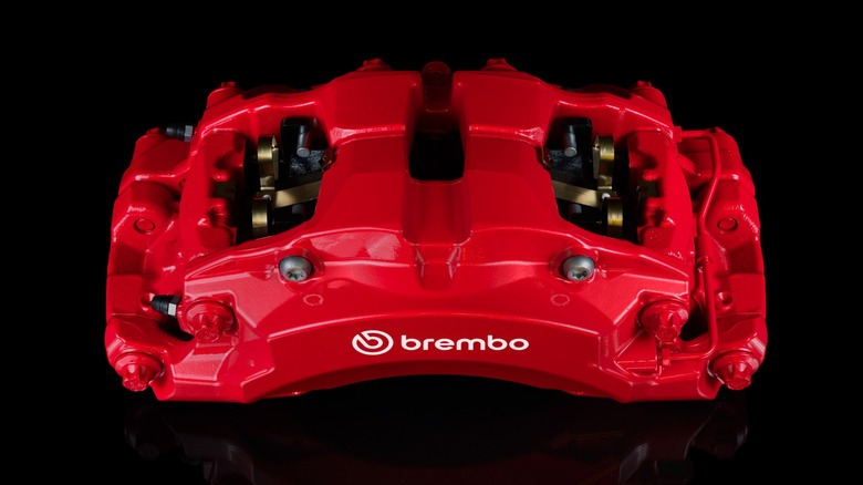 An overhead look at the top of a red Boldika caliper in front of a black background