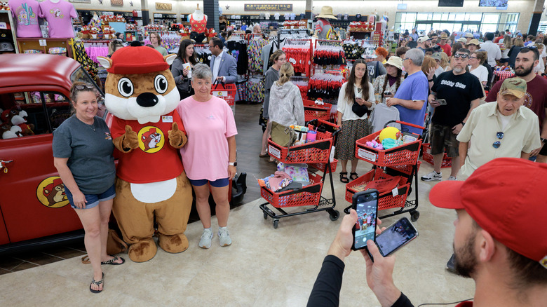 MOUNT CRAWFORD, VIRGINIA - JUNE 30: Customers line up to have their picture taken with the Buc-ee's mascot during the grand opening of the first Buc-ee's location on the East Coast on June 30, 2025 in Mount Crawford, Virginia. The 71,000-square-foot mega-supermarket and 120-pump gas station is the Texas-based chain's 69th store and the first to open outside the southern United States.