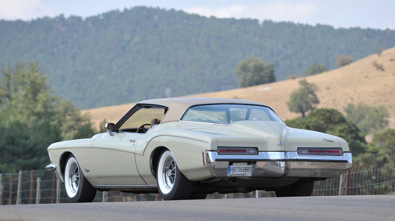 1970s Buick Riviera driver side rear three-quarters on a country road