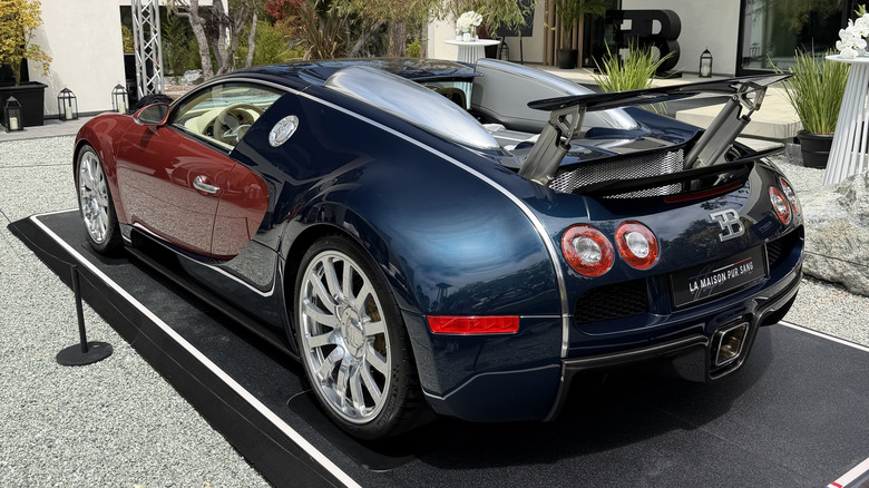 Rear 3/4 view of an orange and blue Bugatti Veyron