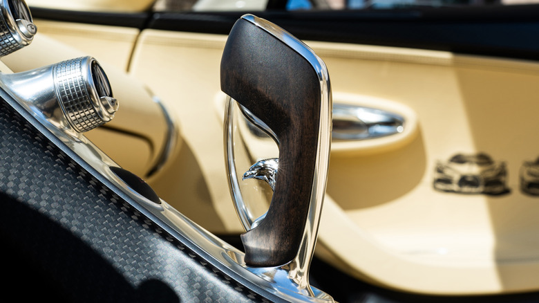 A Bugatti Mistral's wood shifter with a falcon head sculpture