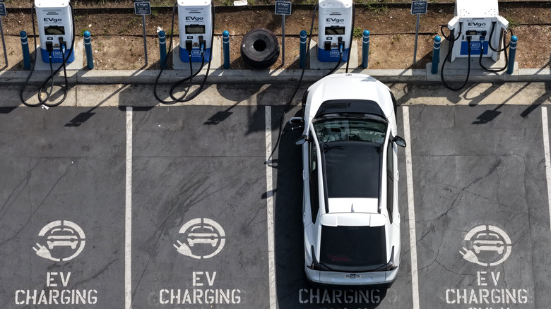 An overhead view of an EV charging at a charging station