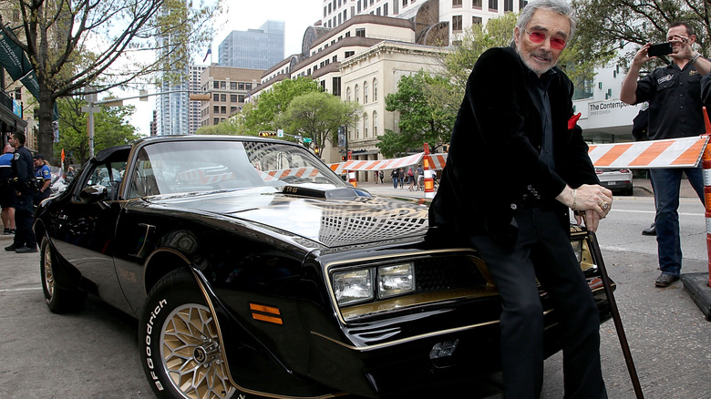 Burt Reynolds poses with a replica of the 1977 Trans Am from Smokey and the Bandit for the premiere of "The Bandit" at the Paramount Theater during the South by Southwest Film Festival on March 12, 2016 in Austin, Texas. (Photo by Gary Miller/Getty Images)