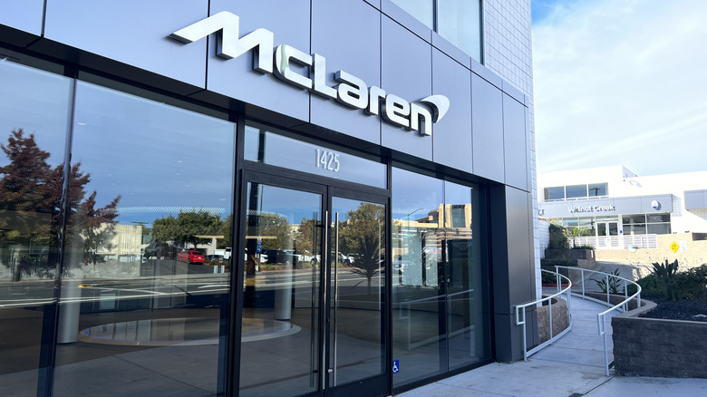 Exterior of McLaren automotive dealership with modern design, clear glass entrance, and company signage, Walnut Creek, California, November 13, 2023.