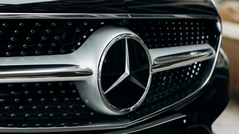 Berlin, August 29, 2018: A close-up of the Mercedes Benz sign on the new black Mercedes-Benz SLC. The inscription in German is translated as young stars.