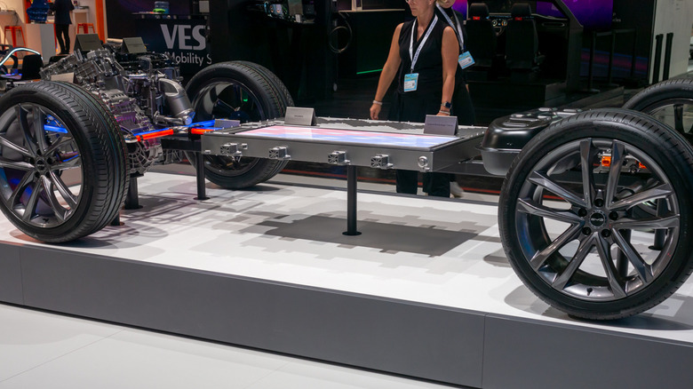 Bare chassis with wheels and visible BYD Blade Battery on display at IAA Summit 2023 in Munich, Germany