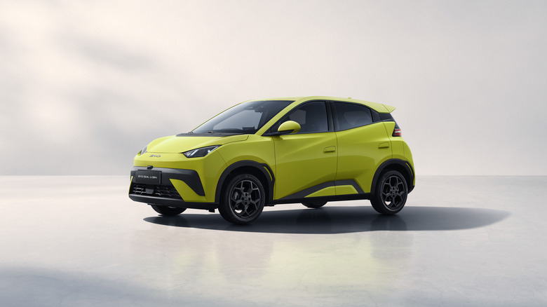 Yellow BYD Dolphin Surf seen in left front three-quarter view in studio