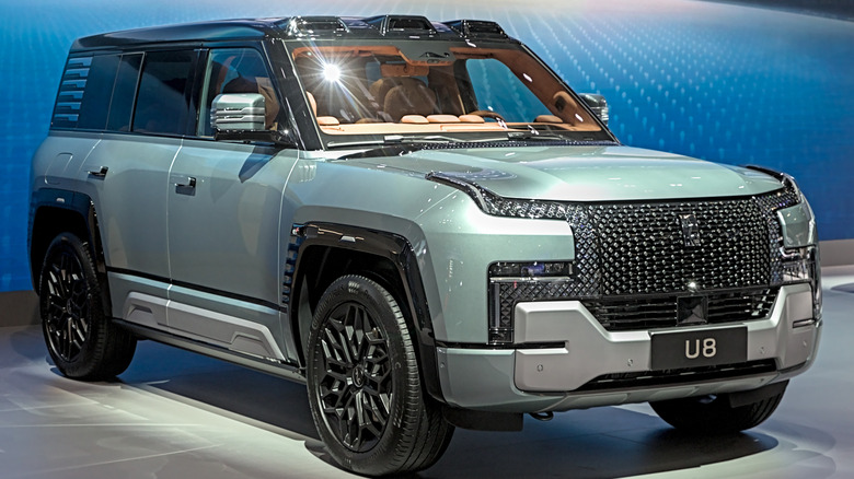 BYD's YangWang U8 ultra-luxury SUV seen in right-front three-quarter view on display indoors