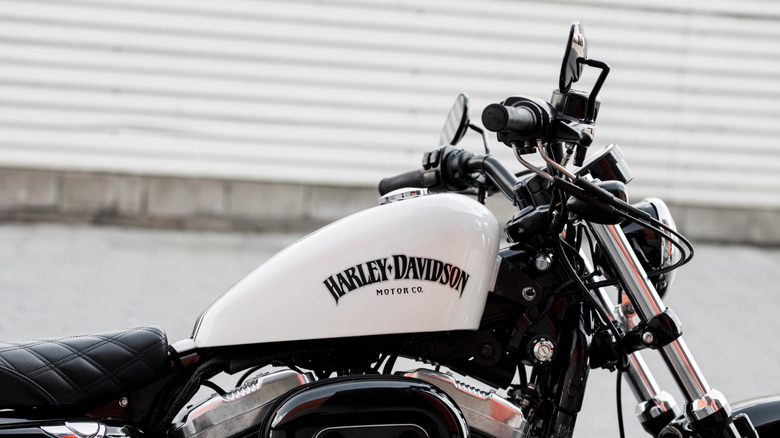 Minsk, Belarus, May 2023 - Harley-Davidson logo on motorcycle. Vintage style racer motorcycle with details.