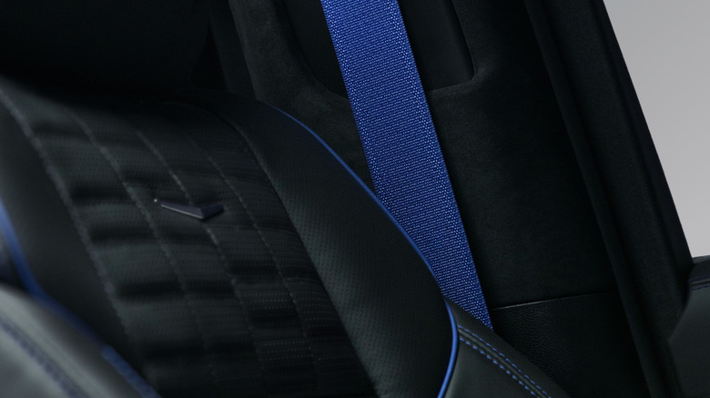 Close-up of the black interior of the special edition Escalade showing the blue stitching, seat piping, and seat belt