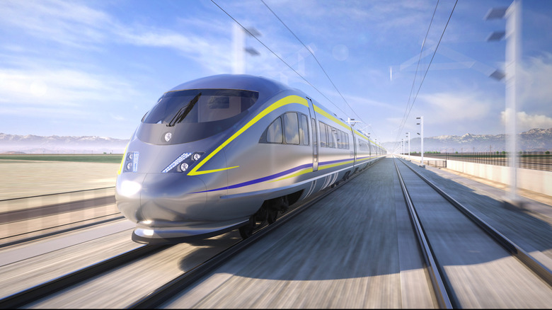 a front three-quarters rendering of a silver bullet train with yellow and blue decals speeding along a rendered railroad in front of a blue sky and mountain range in the distance